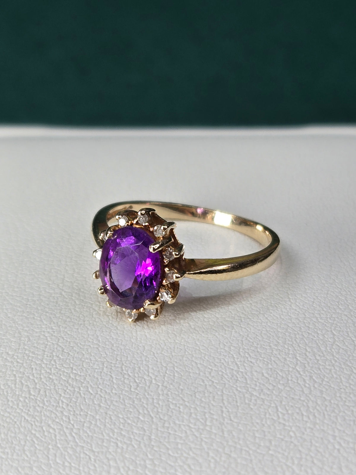 angled shot showing amethyst depth and halo diamonds