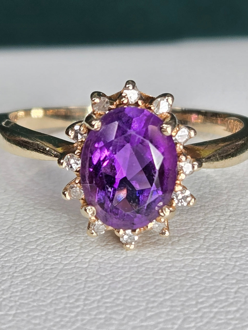 top view of amethyst and diamond halo ring