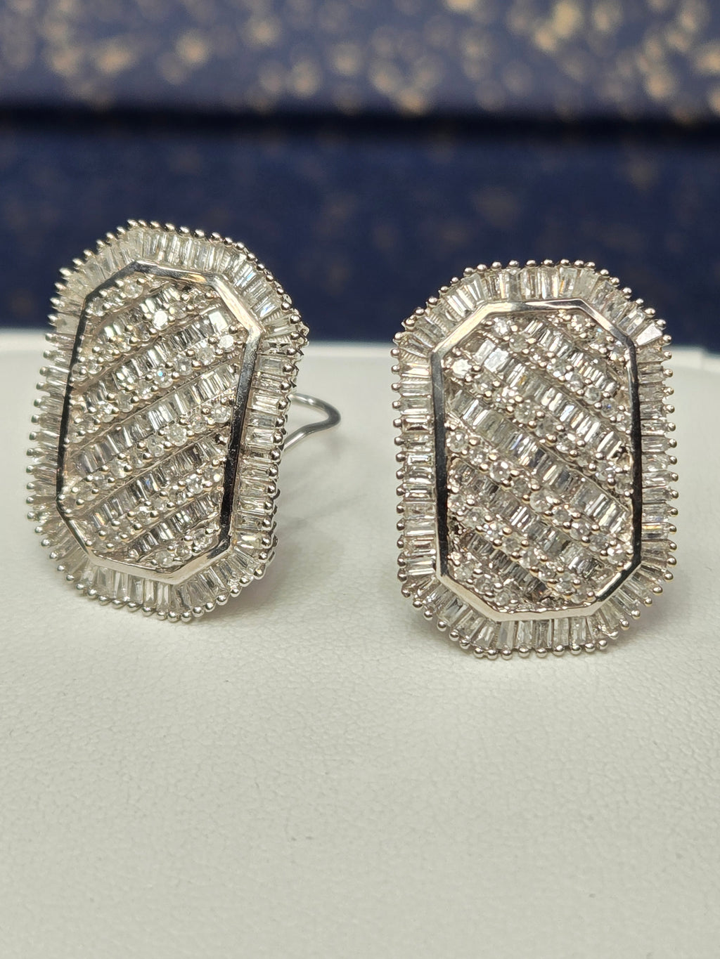 pair of 14k white gold earrings front view showing baguette and round diamonds