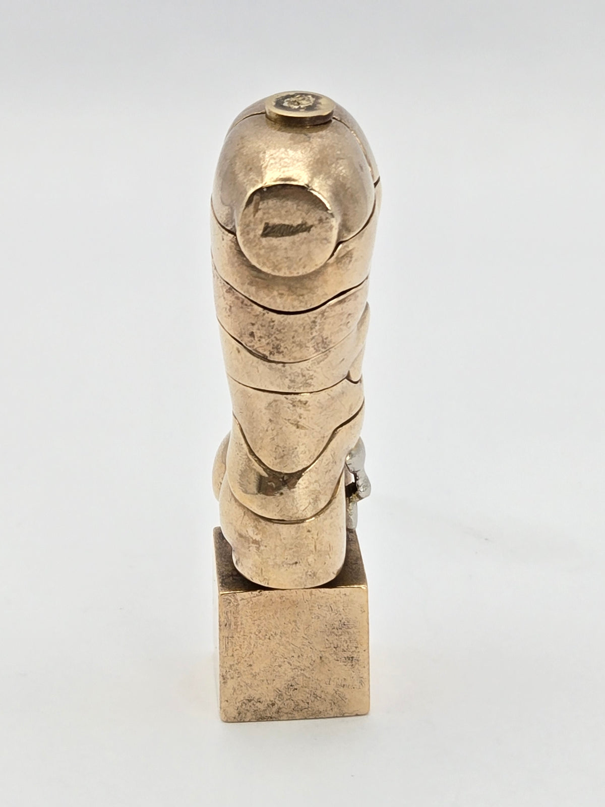 angled studio shot of brass sculpture highlighting joins
