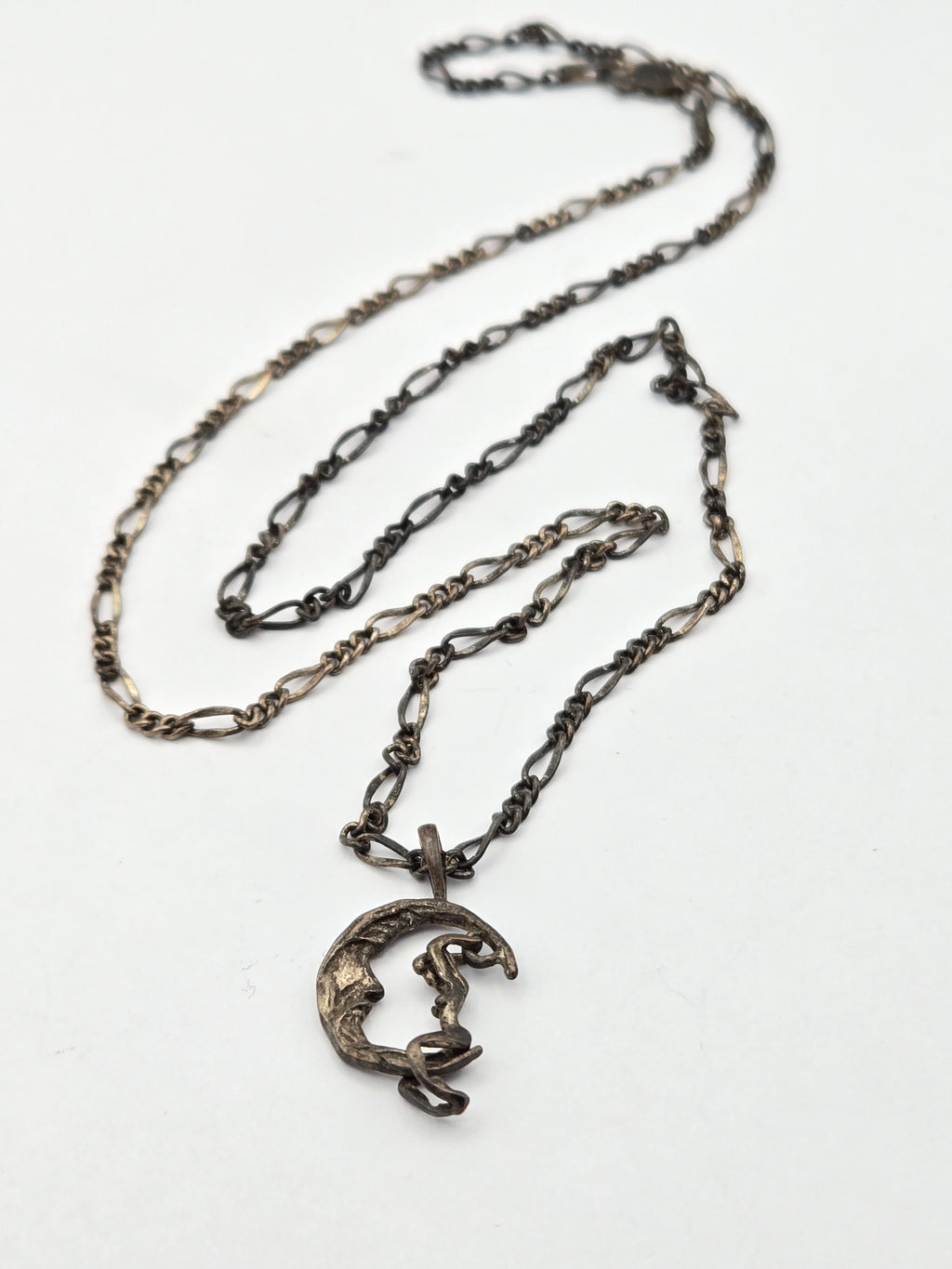 pendant on chain showing moon rider on crescent motif
