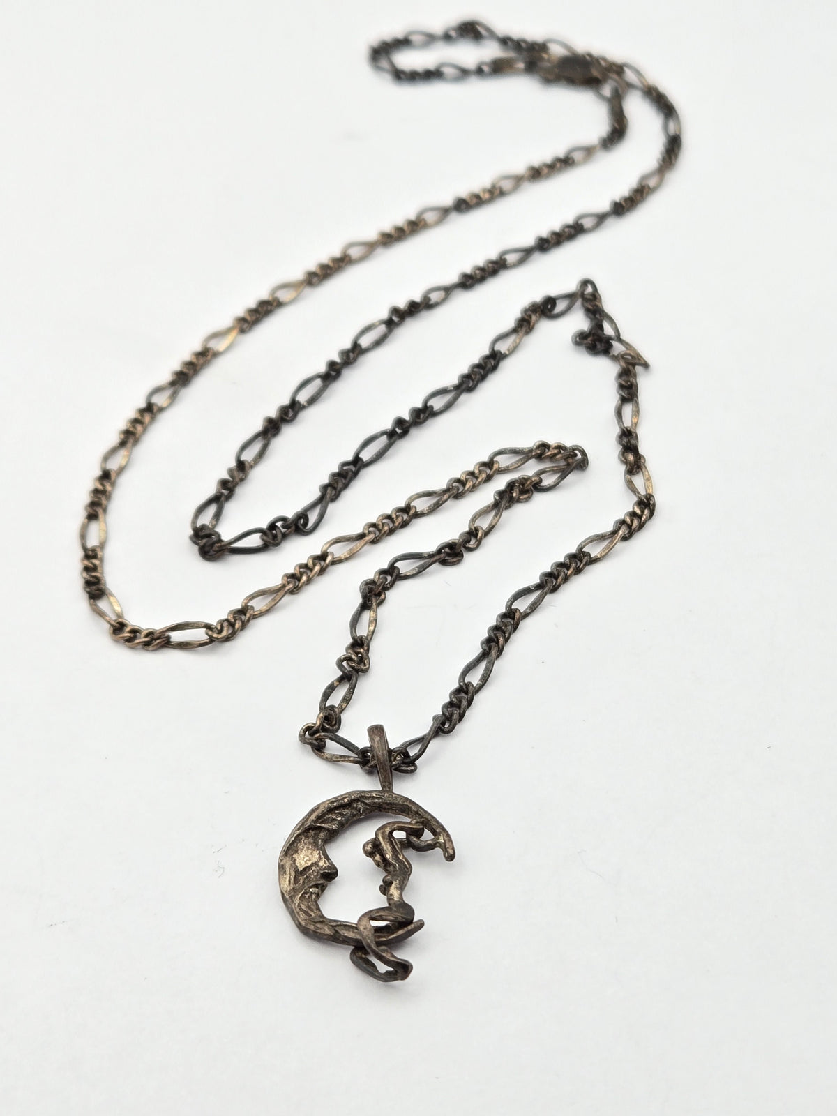 pendant on chain showing moon rider on crescent motif