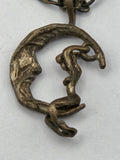 Sterling silver pendant of a moon rider on a crescent moon with accompanying chain.