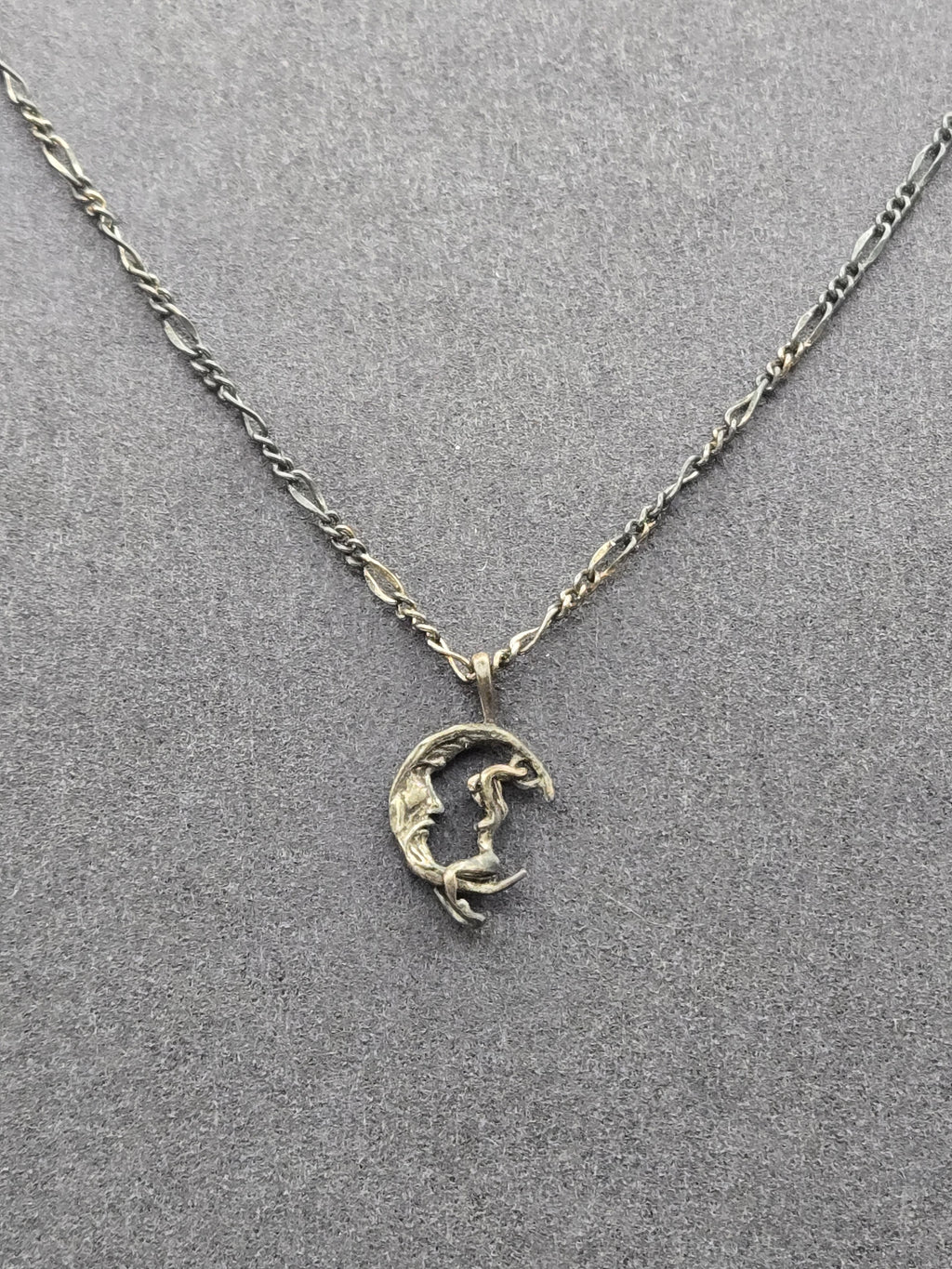 pendant against dark background showing chain length and clasp