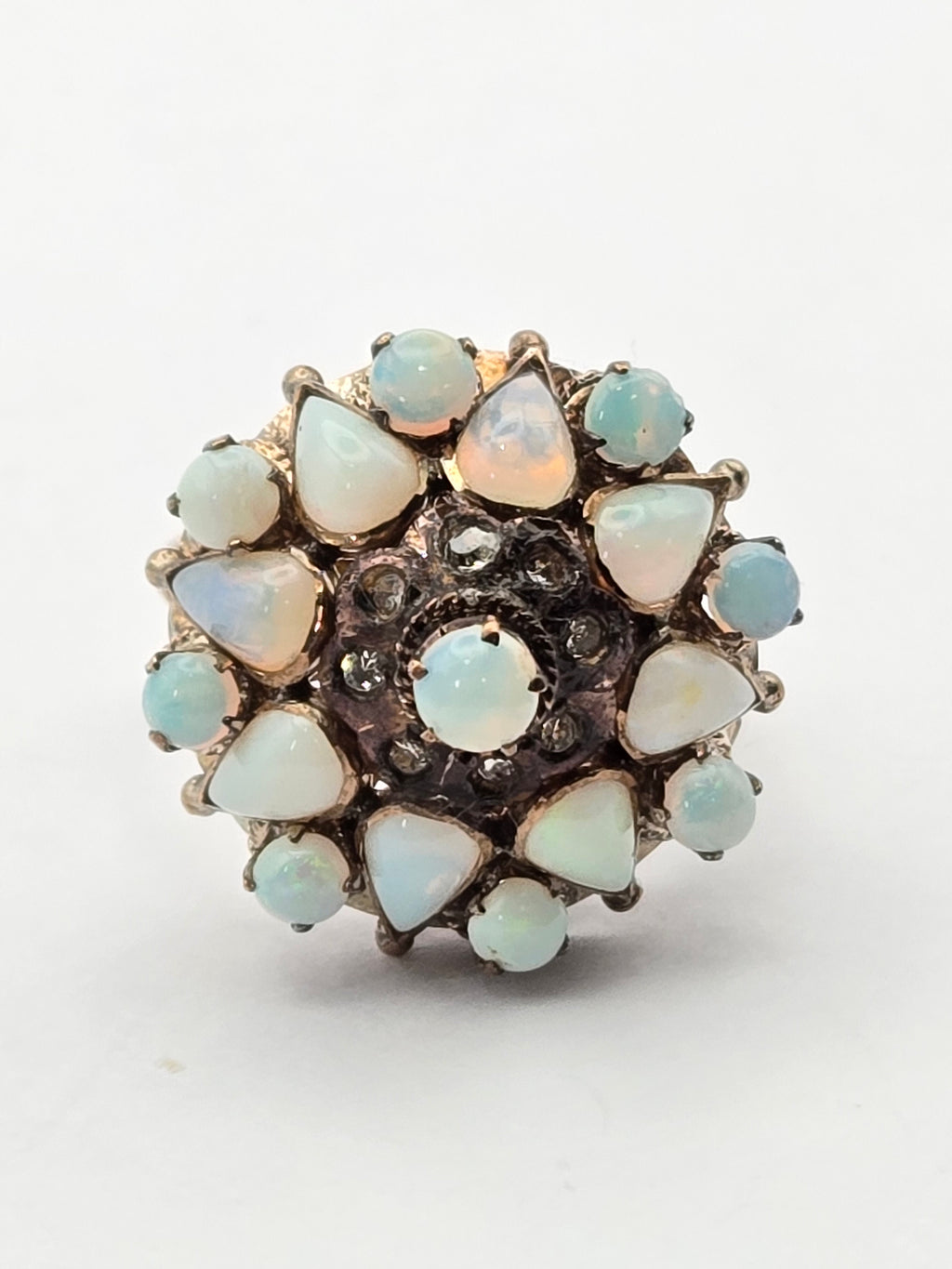 close-up of opal center and delicate filigree band, lit from above