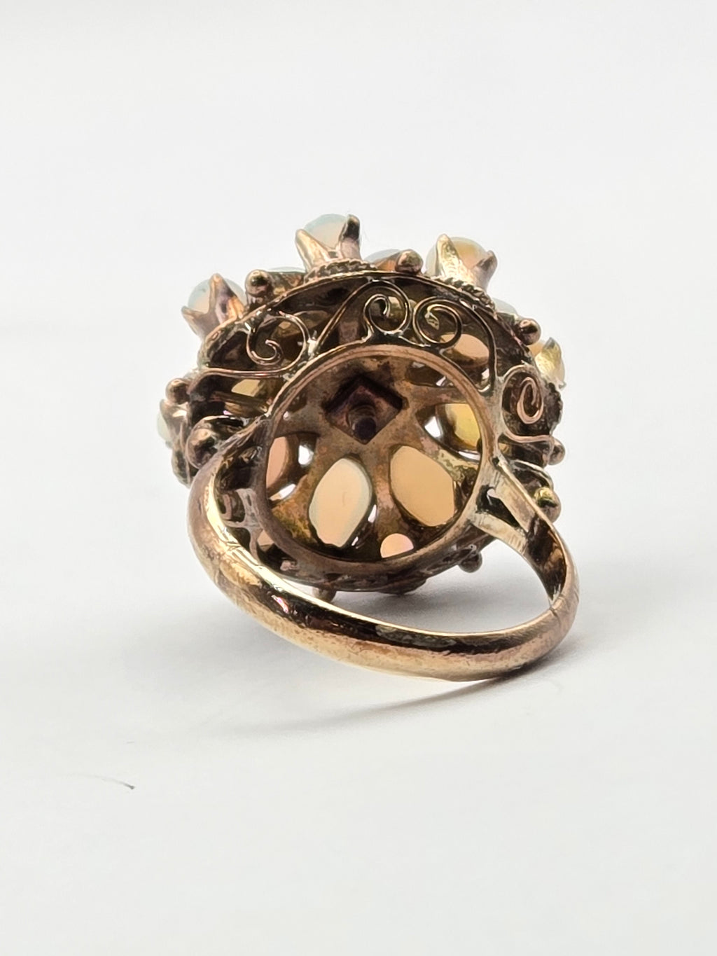 angled view showing opal cabochon and hand-wrought openwork gallery