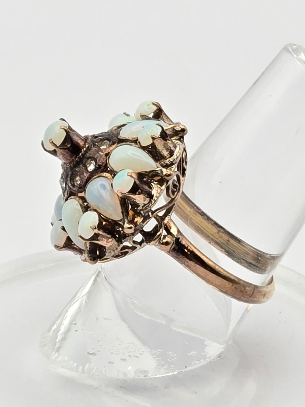 ring on neutral background highlighting opal color and filigree