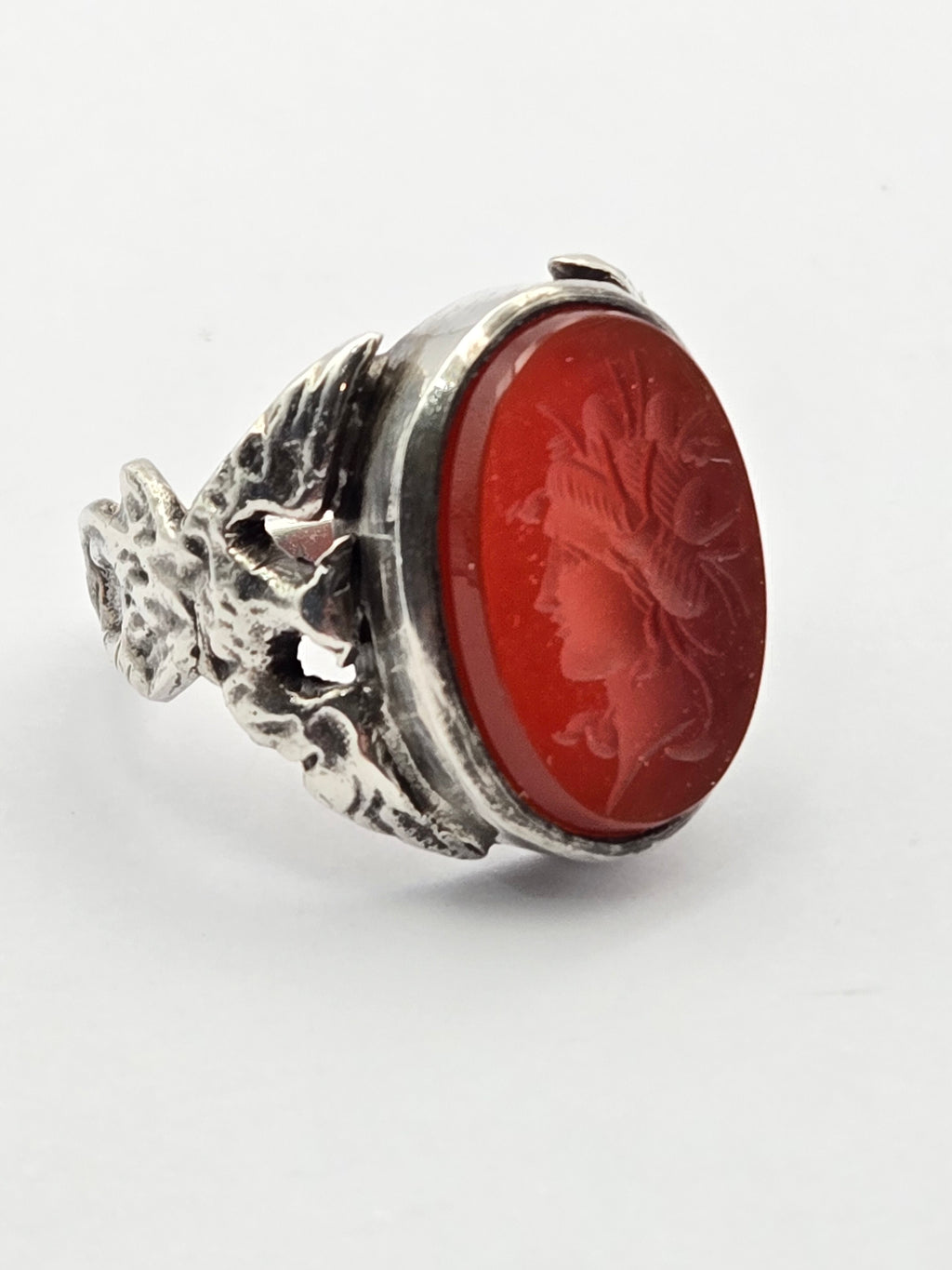 Sterling ring featuring a carved carnelian intaglio of a goddess with eagle motif.