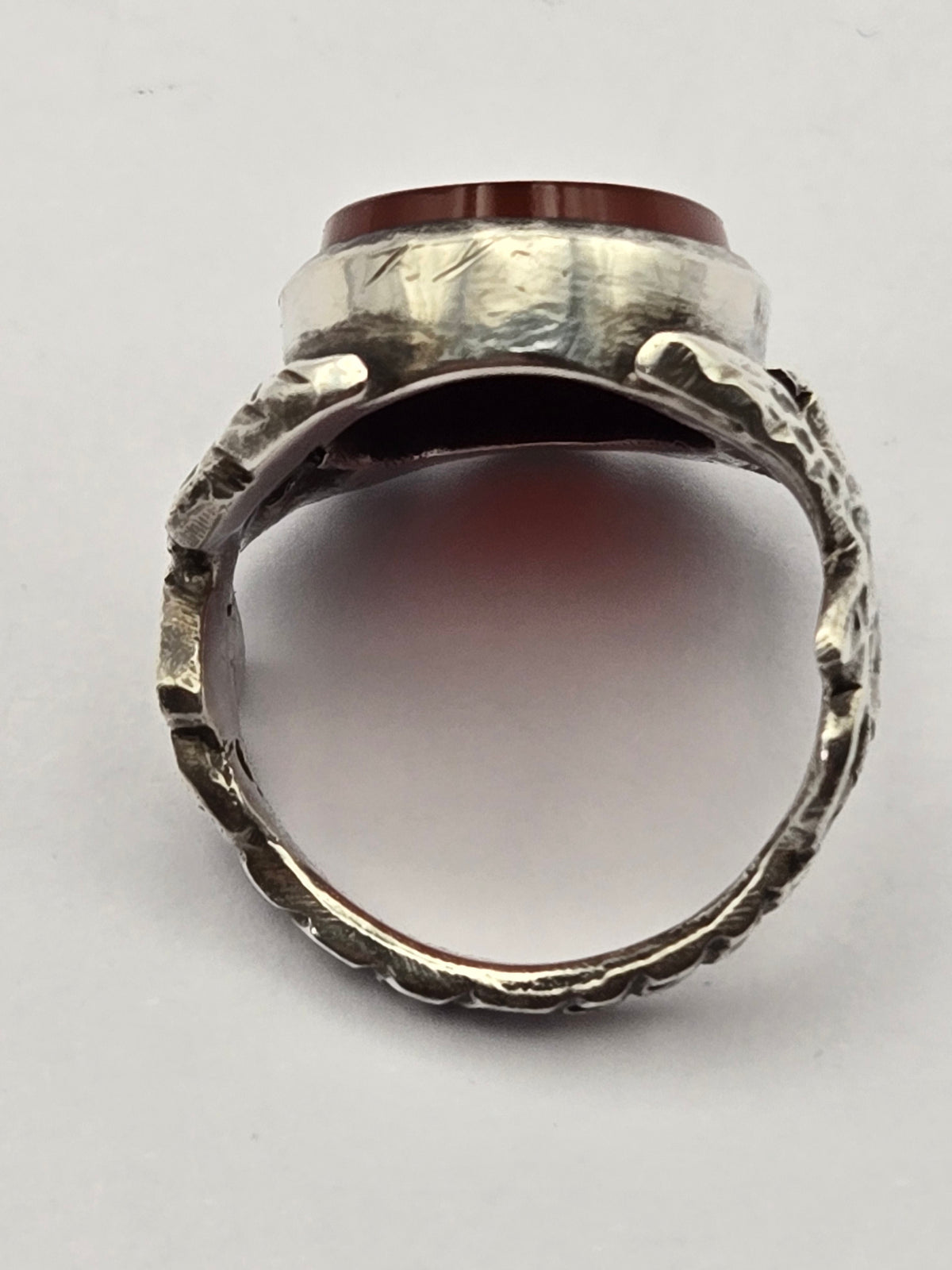 detail of bezel engraving and patina