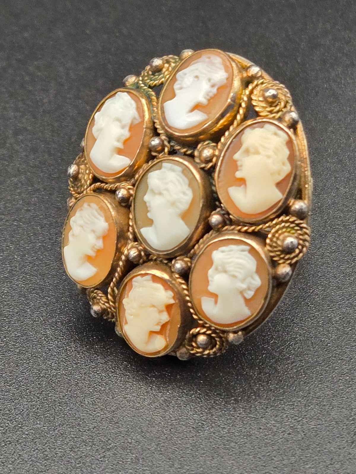 top view of domed cameo ring with seven shell cameos