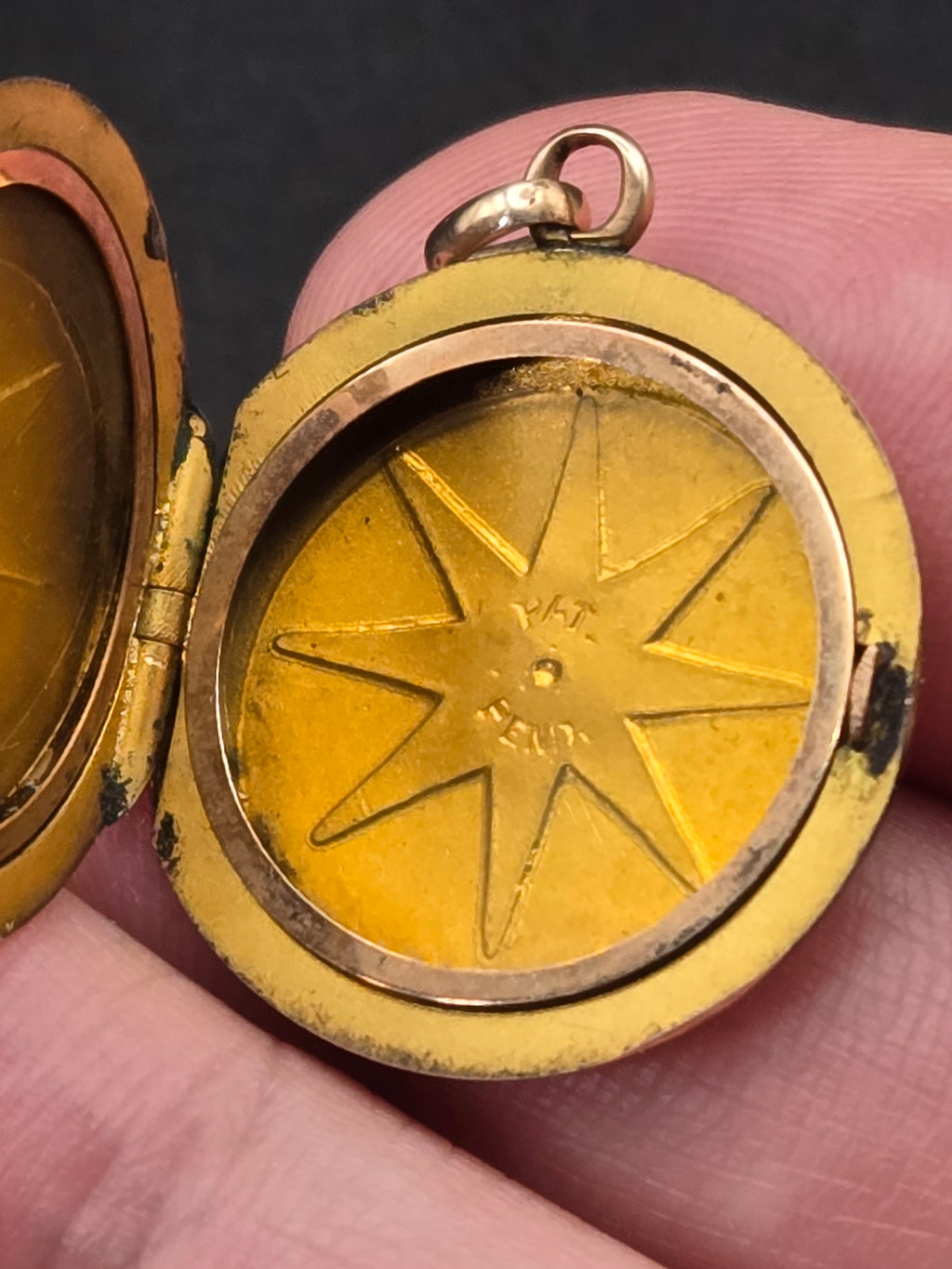 open locket showing interior photo frame and star engraving