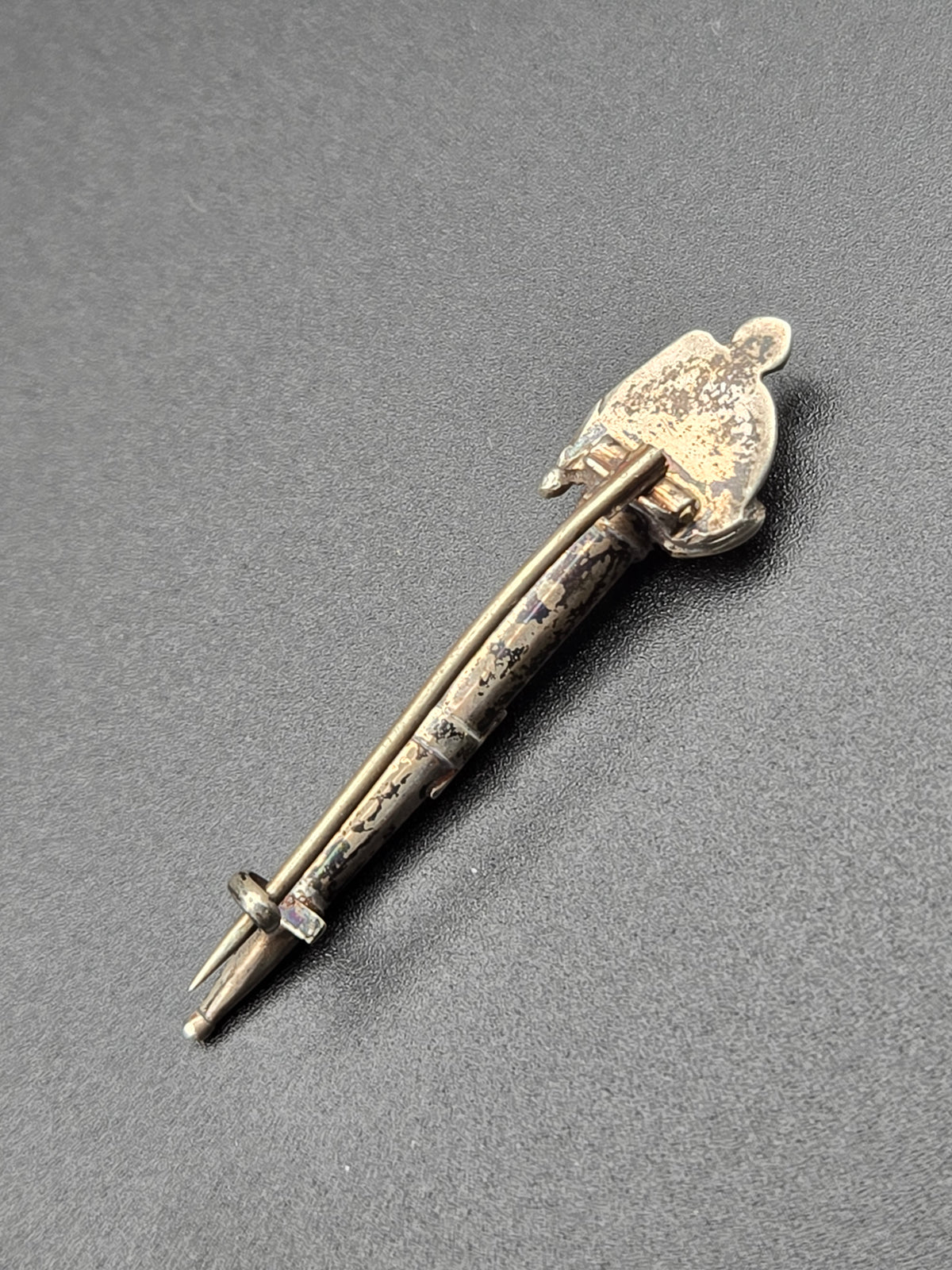side profile showing pin mechanism and ornate details