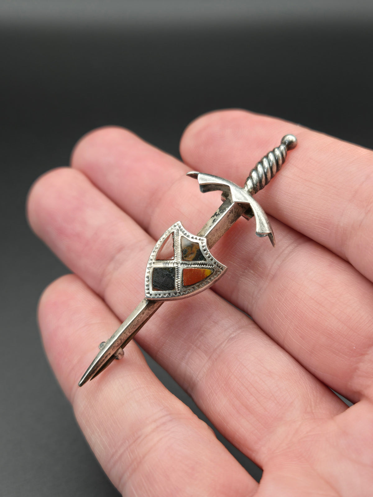 top view of sword kilt pin with bloodstone and agate in sterling setting