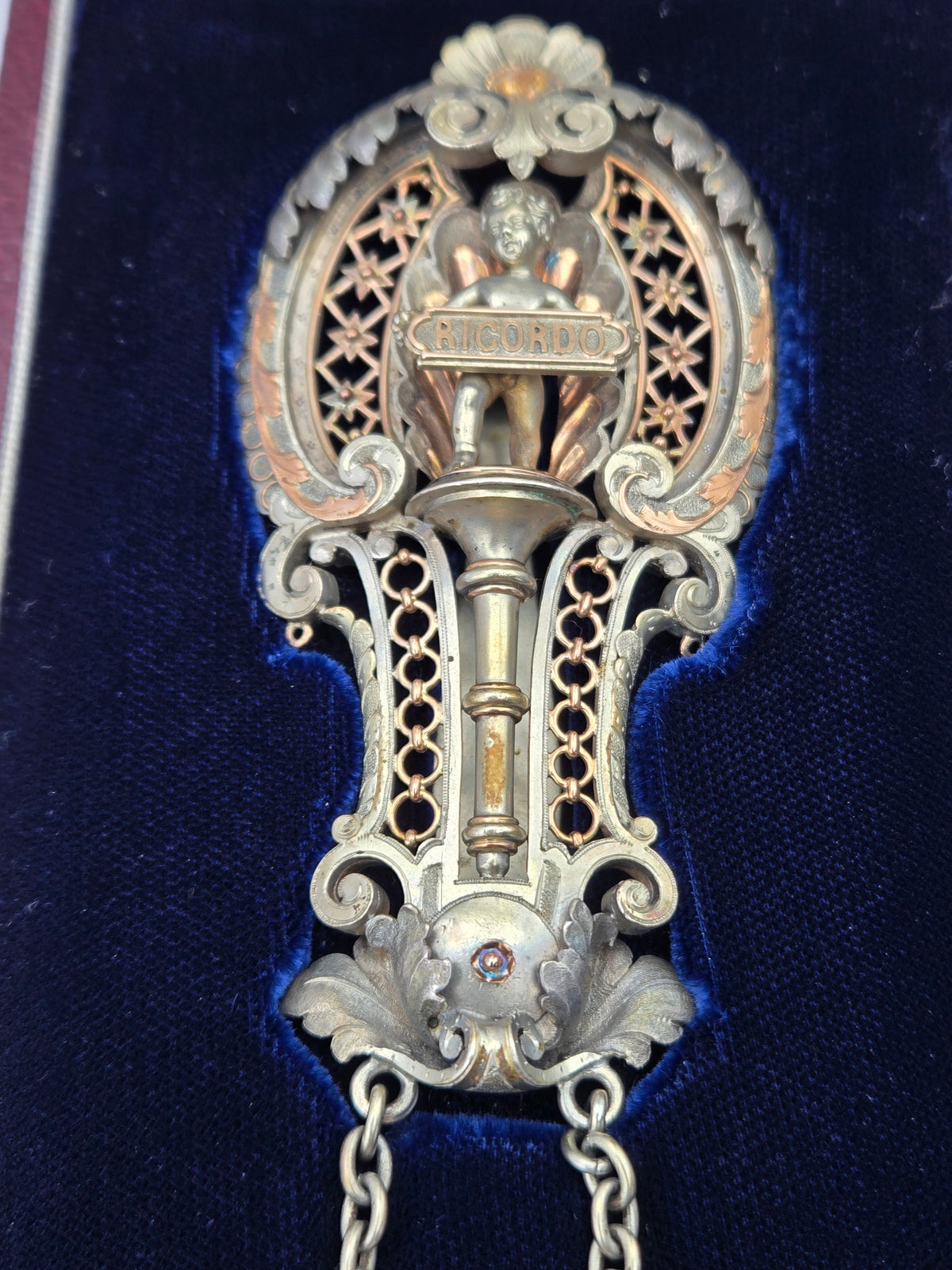 angled shot showing gold and sterling details and belt clip