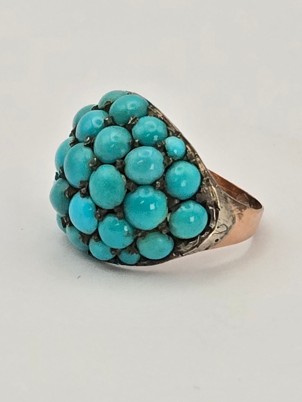 Antique bombe ring in 9k gold set with Persian turquoise stones and silver prongs.