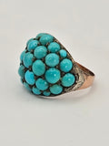 Antique bombe ring in 9k gold set with Persian turquoise stones and silver prongs.