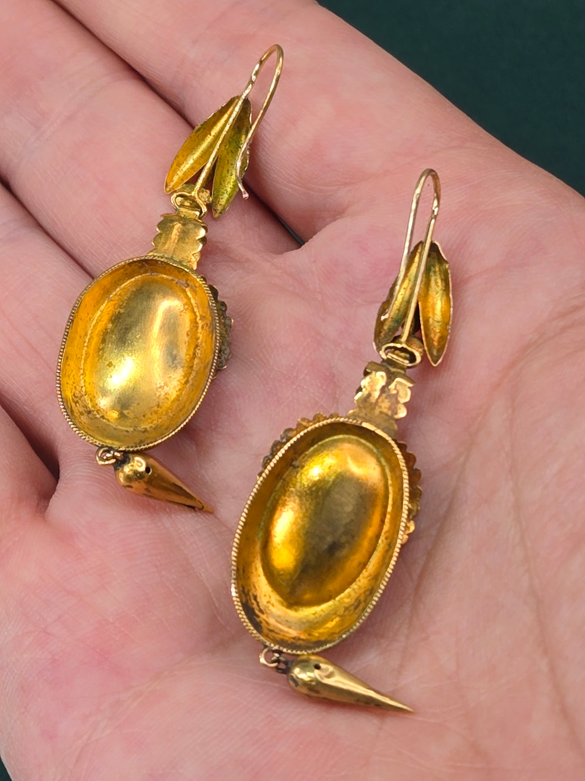 Antique 18k gold Victorian garnet earrings, detail view of filigree and stone setting.